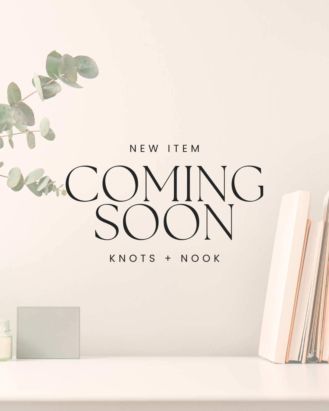 a white shelf with a plant and some books, along with a text overlay that announces a new item coming soon.