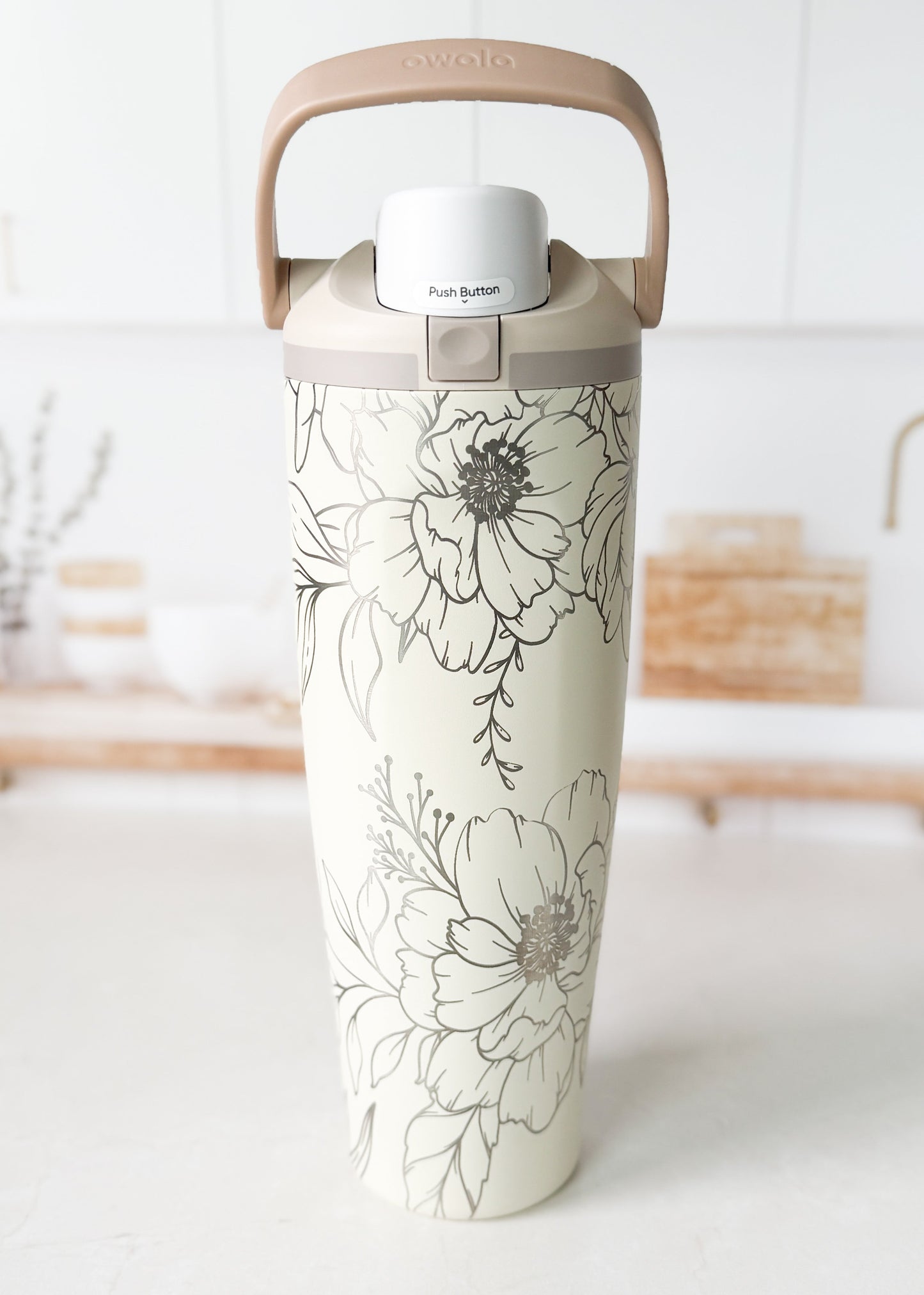 Tumbler with floral design on a white surface